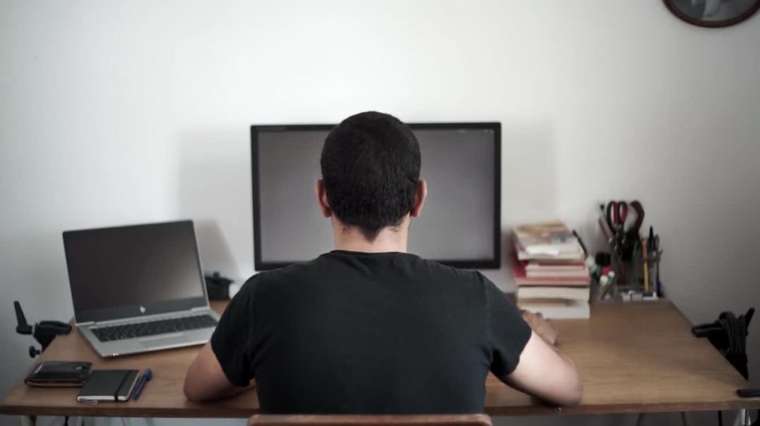Stock business video of man working at computer desktop